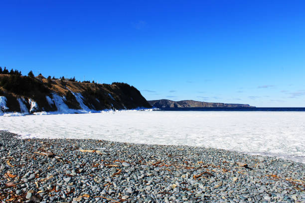 istock Ice in the bay and on the beach and cliffs, Outer Cove, Newfoundland, Canada 1157806351