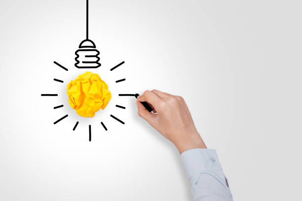 istock New Idea Concepts Light Bulb Crumpled Yellow Paper on White Background 1157806612