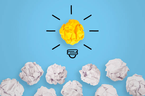 istock Innovative Idea Concepts Light Bulb Crumpled Yellow Paper on Blue Background 1157806659