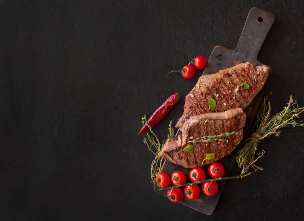 grilled beef steak, greens, tomatoes and spices. top view with copy space for text - food and drink steak meat food imagens e fotografias de stock
