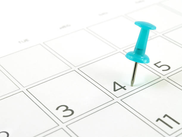 close up single blue plastic push pin tacking in schedule box of 4th of July on white desk calendar page pin for important appointments, Independence Day (American national day) concept calendar today personal organizer routine stock pictures, royalty-free photos & images