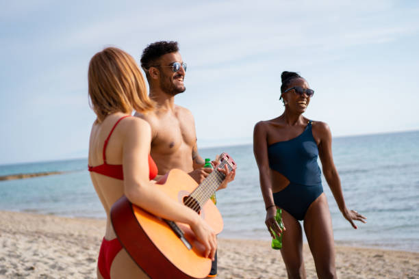 istock Friends enjoying summer on the beach 1157808858
