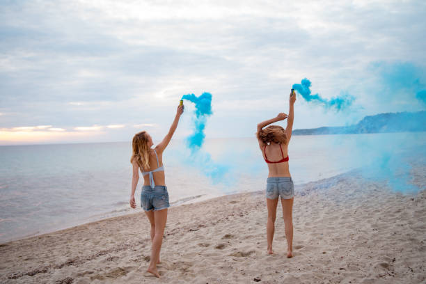 istock Female friends having fun on the beach 1157809218