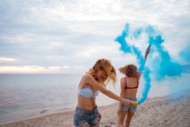istock Female friends having fun on the beach 1157809223