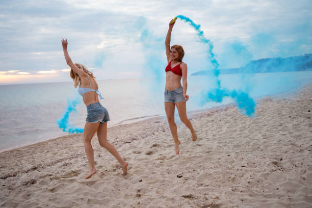 istock Female friends having fun on the beach 1157809269