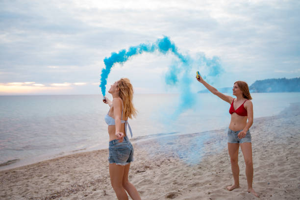 istock Female friends having fun on the beach 1157809807