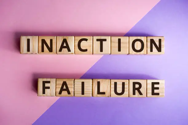 phrase inaction failure, wooden cubes with letters on color background top view