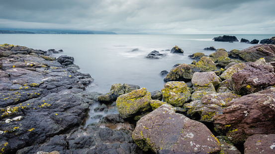 On Skernaghan Point’s rocky shoreline, Browns Bay, Islandmagee, County Antrim, Northern Ireland.