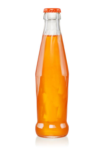 Orange carbonated soft drink in glass bottle isolated Orange fruit carbonated soft drink in small glass bottle isolated on white background soda bottle photos stock pictures, royalty-free photos & images