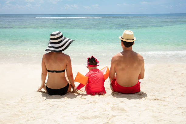 istock Couple Sitting With Her Daughter Looking At Sea 1157815140