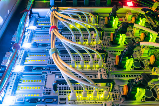 istock Central hosting platform of powerful computer equipment. The back panel of modern web servers is a close up. The network wires connect to the high-speed interfaces of the main router. High performance data center. 1157816540