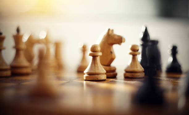 istock Wooden chess pieces on the chessboard. 1157818052