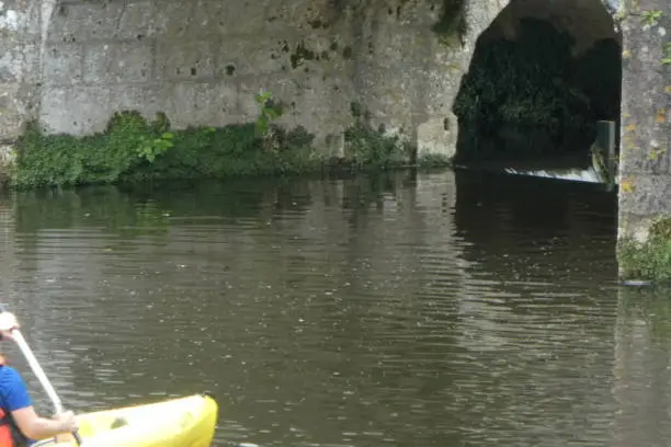 canoe kayak on the Dronne in Brantôme in dordogne
the person will pass under the elbow bridge