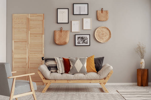 istock Red, yellow and patterned pillows on elegant scandinavian living room sofa 1157820024