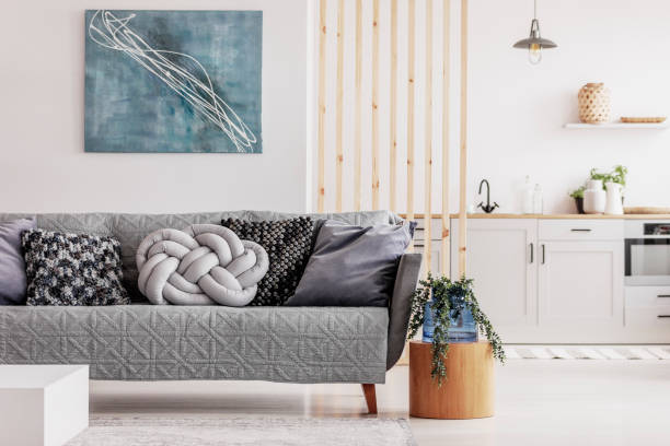 istock Wooden mullins wall in bright open plan studio apartment with kitchen and living room 1157821243