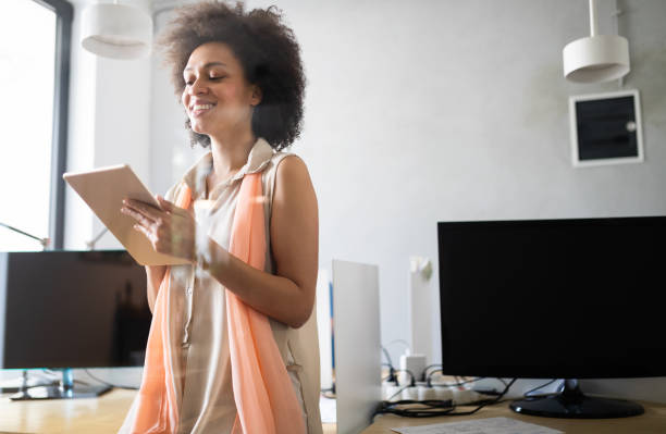 istock Young african american woman working with tablet in office 1157822603
