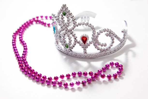 Costume princess dress up A plastic jeweled crown or tiara with purple beads on a white background prom queen stock pictures, royalty-free photos & images