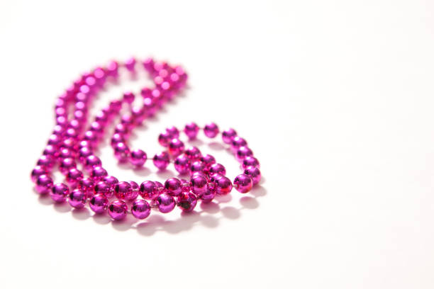 Purple pink beads against a white background