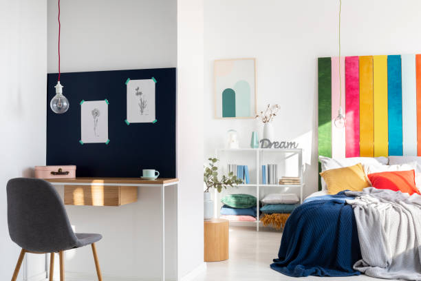 istock Colorful bedroom interior with king size bed and home office 1157824594