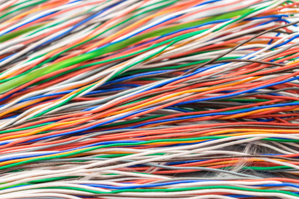 istock Many thin electrical wires of different colors. Cables for telephone and internet connection. Abstract technology background. 1157824696