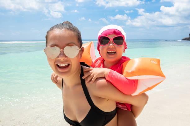 istock Daughter Enjoying The Piggyback Ride At Beach 1157826081