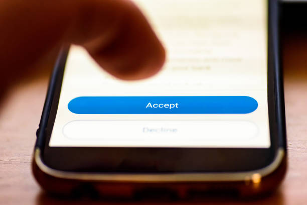 istock Accept button on smartphone screen closeup with human finger pointing to it 1157826355