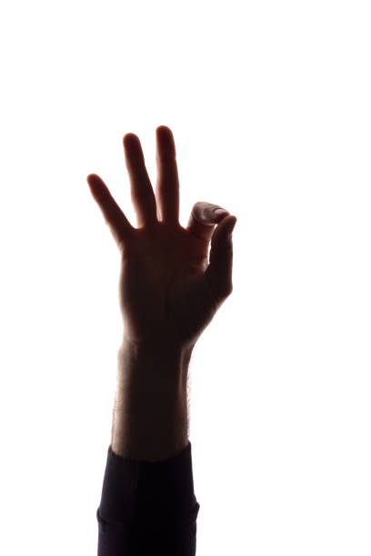 istock Hand young man shows symbol ok, like - silhouette concept abstraction 1157829004