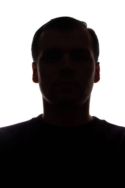 istock Portrait of a young man, front view - dark isolated silhouette 1157829217