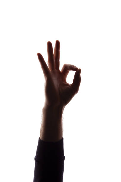 istock Hand young man shows symbol ok, like - silhouette concept abstraction 1157829254