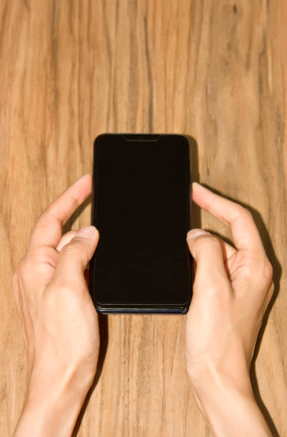 istock Female hand holding a cell phone 1157829349