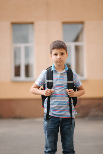 istock Cute little boy with backpack go home after scholl class 1157829919