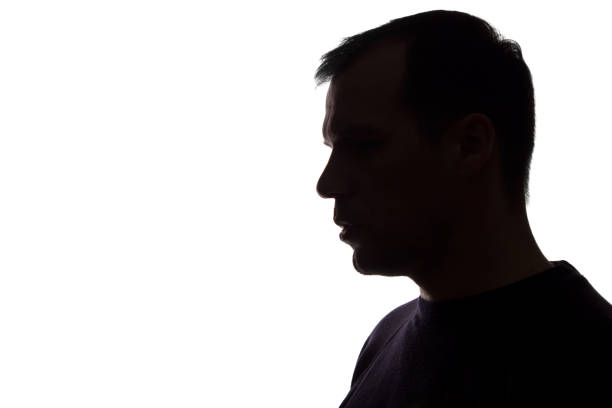 istock Portrait of a young man, side view - dark isolated silhouette 1157830232