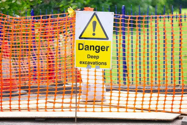 istock Danger deep excavation sign and orange net security 1157830234