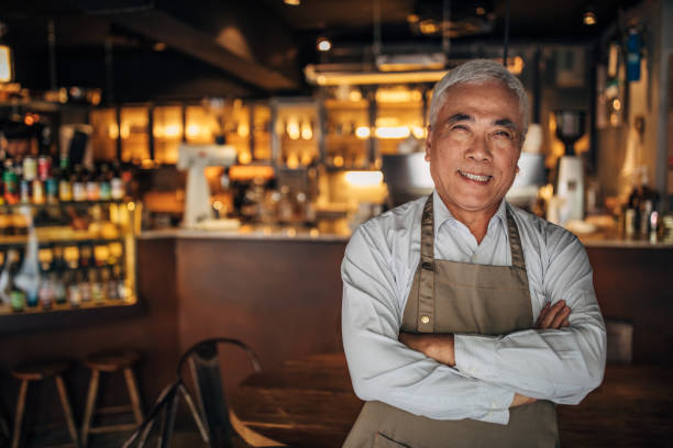 istock Senior cafe owner in uniform 1157831428