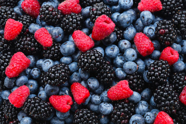 istock Blackberry, raspberry, blueberry background.  Top view. 1157831810