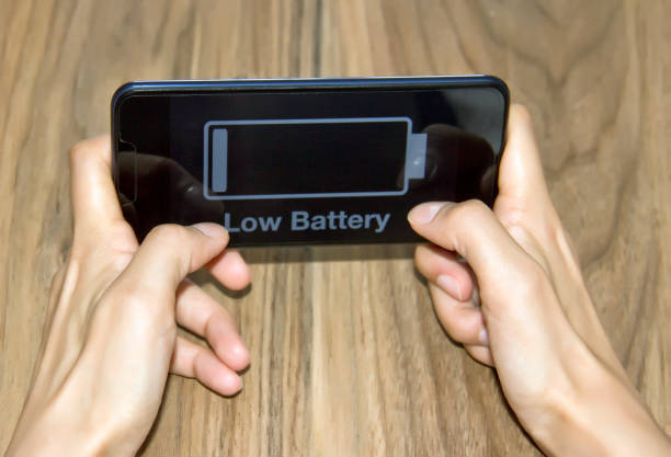 Girl chatting with friend on mobile phone low battery