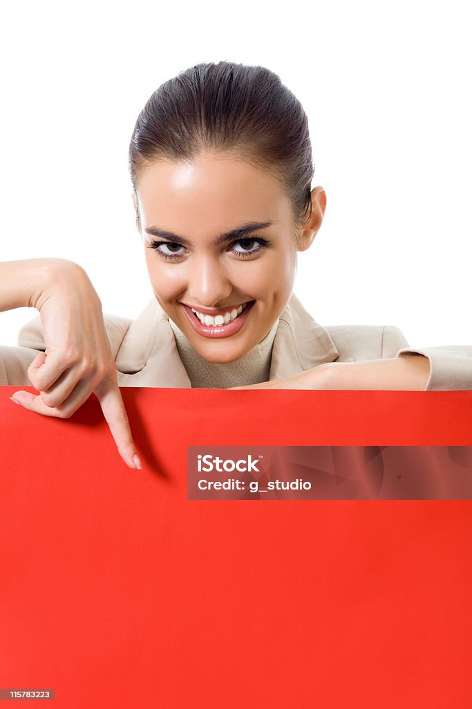 Happy young business woman showing blank red signboard, isolated Happy young business woman showing blank red signboard, isolated on white background Adult Stock Photo
