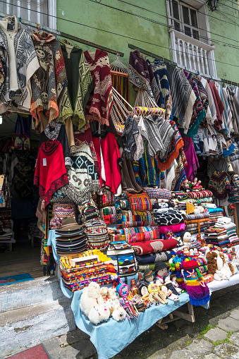 Colorful souvenirs hanging in front of a small store in Alausi.