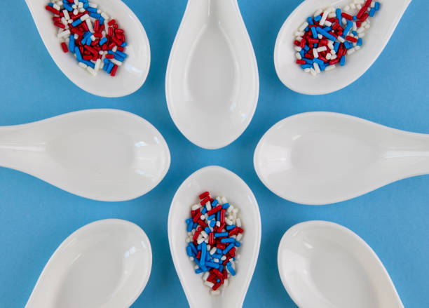 istock Red, white and blue sprinkles in white spoons on blue background. Flat lay. 1157834094