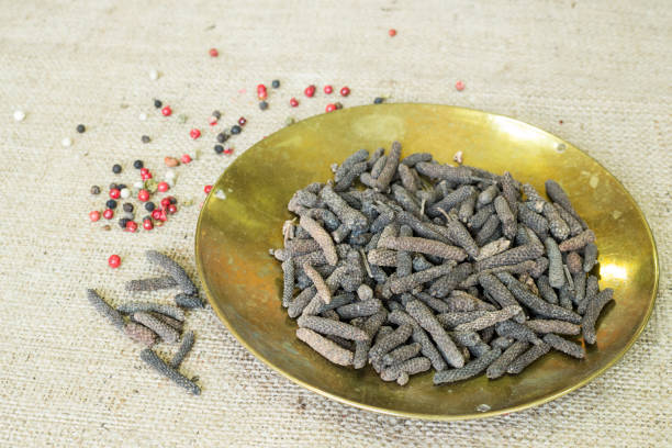 long pepper indonesian long peppercorns in metal plate capsicum annuum longum stock pictures, royalty-free photos & images