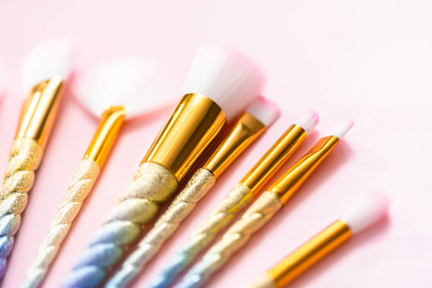 istock Unicorn color makeup brushes on a pink background. 1157837048