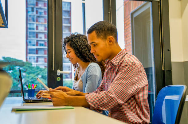 istock Young entrepreneurs at work. Young entrepreneurs with laptop and tablet at work place 1157837486