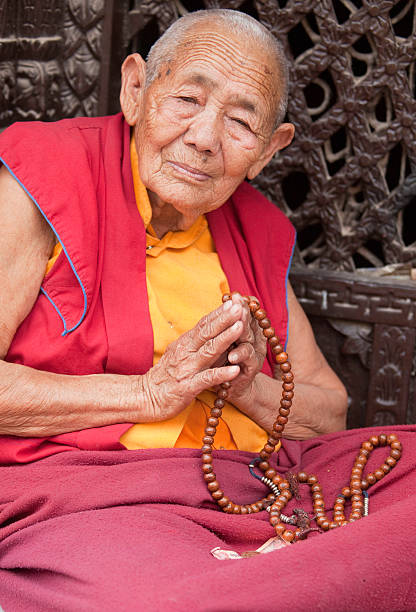 Monk with Mala Prayer beads stock photo