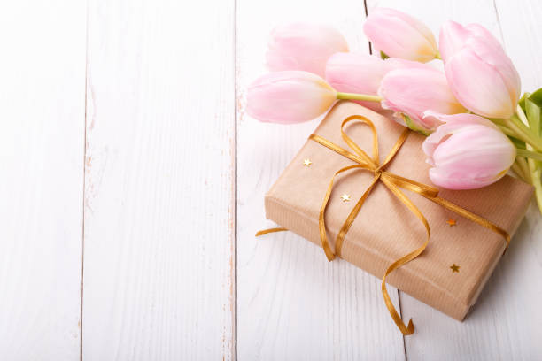 istock Gift box and pink tulips 1157840950