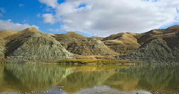 Reflected Coulee Hills Hills reflected in the Oldman River at Popson Park in Lethbridge, Alberta, Canada. lethbridge alberta stock pictures, royalty-free photos & images