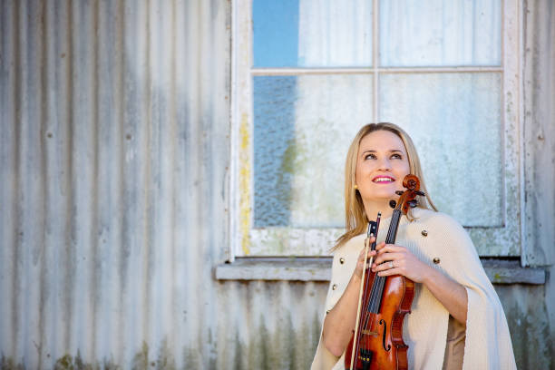 istock Female Musician Posing With Vintage Violin 1157844841
