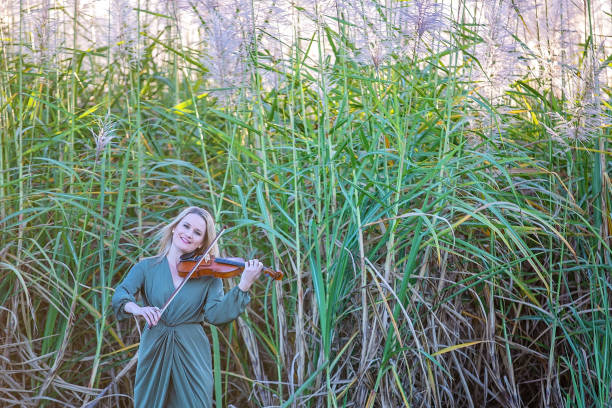 istock Beautiful Woman Playing Violin At Sunset 1157845357