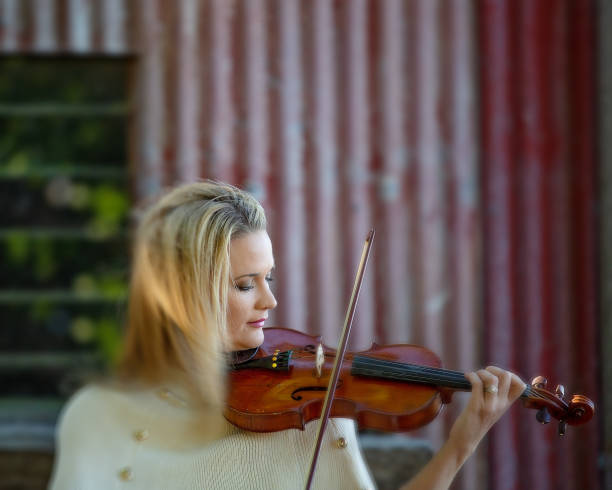 istock Female Violinist Playing Antique Instrument 1157845447