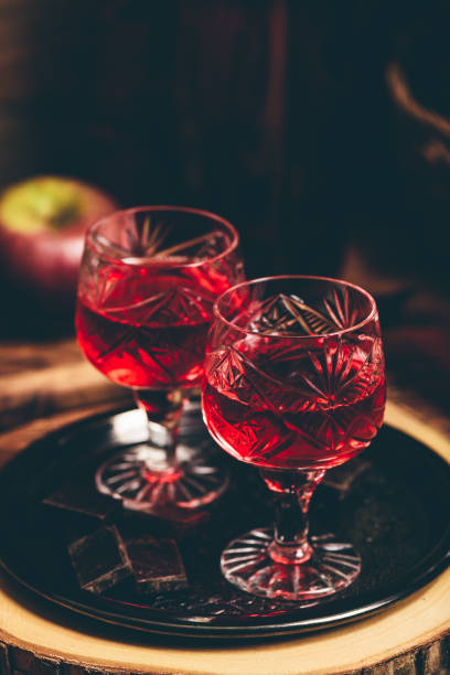 Glass of red liquor with chocolate bars Glass of red liquor with chocolate bars on metal tray nalewka stock pictures, royalty-free photos & images