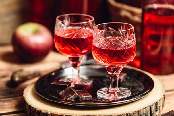 Glass of red liquor with chocolate bars Glass of red liquor with chocolate bars on metal tray nalewka stock pictures, royalty-free photos & images